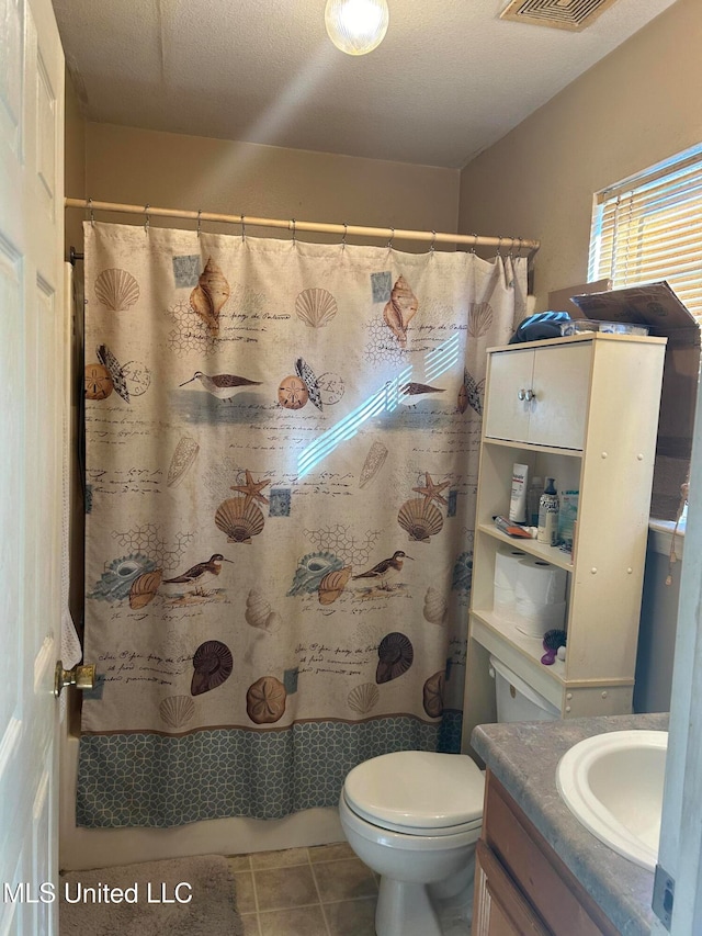 bathroom featuring tile patterned flooring, a textured ceiling, toilet, vanity, and a shower with shower curtain