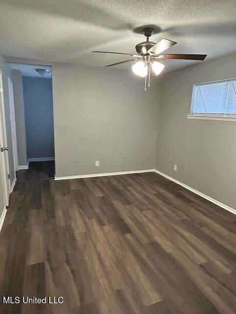 805 Choctaw Dr, Laurel, MS 39440 - unfurnished room featuring ceiling fan, a textured ceiling, dark wood finished floors, and baseboards