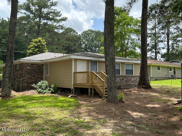 805 Choctaw Dr, Laurel, MS 39440 - rear view of house with brick siding and a lawn