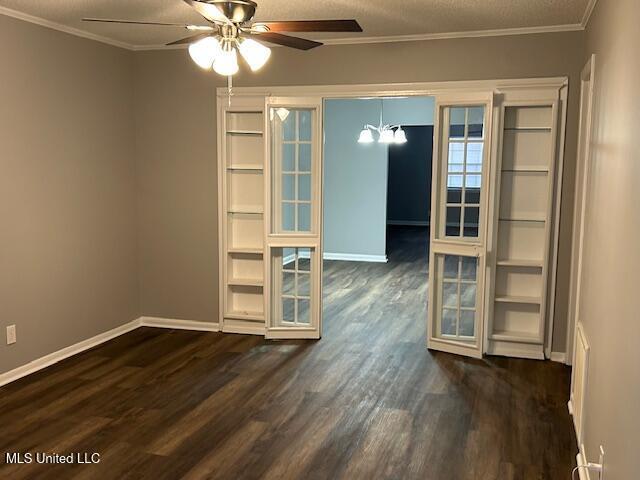 805 Choctaw Dr, Laurel, MS 39440 - spare room with dark wood finished floors, ceiling fan, baseboards, and crown molding