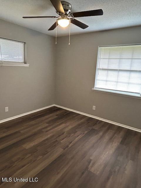 805 Choctaw Dr, Laurel, MS 39440 - unfurnished room featuring ceiling fan, baseboards, and dark wood-type flooring