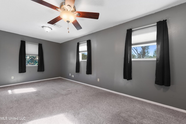 carpeted empty room featuring ceiling fan