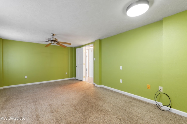 unfurnished room featuring carpet flooring, ceiling fan, and a textured ceiling