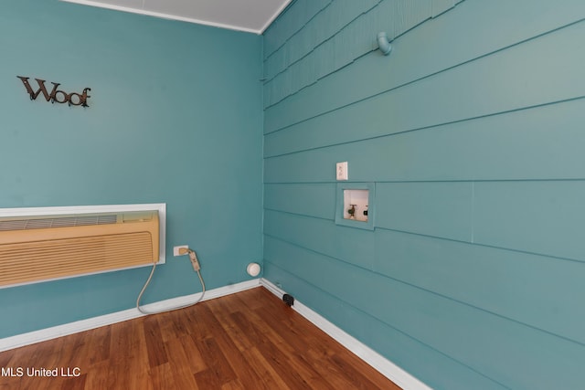 clothes washing area featuring washer hookup, crown molding, and hardwood / wood-style floors