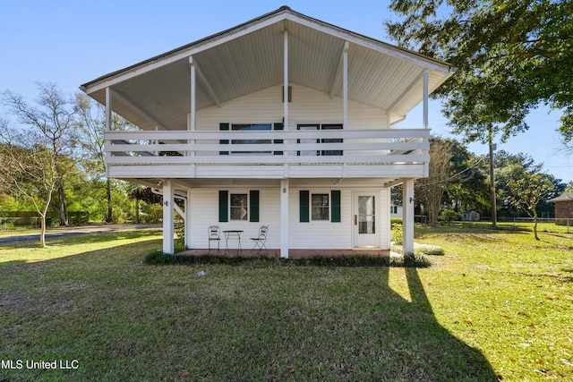 rear view of house featuring a lawn