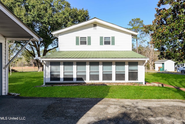 back of property featuring a yard