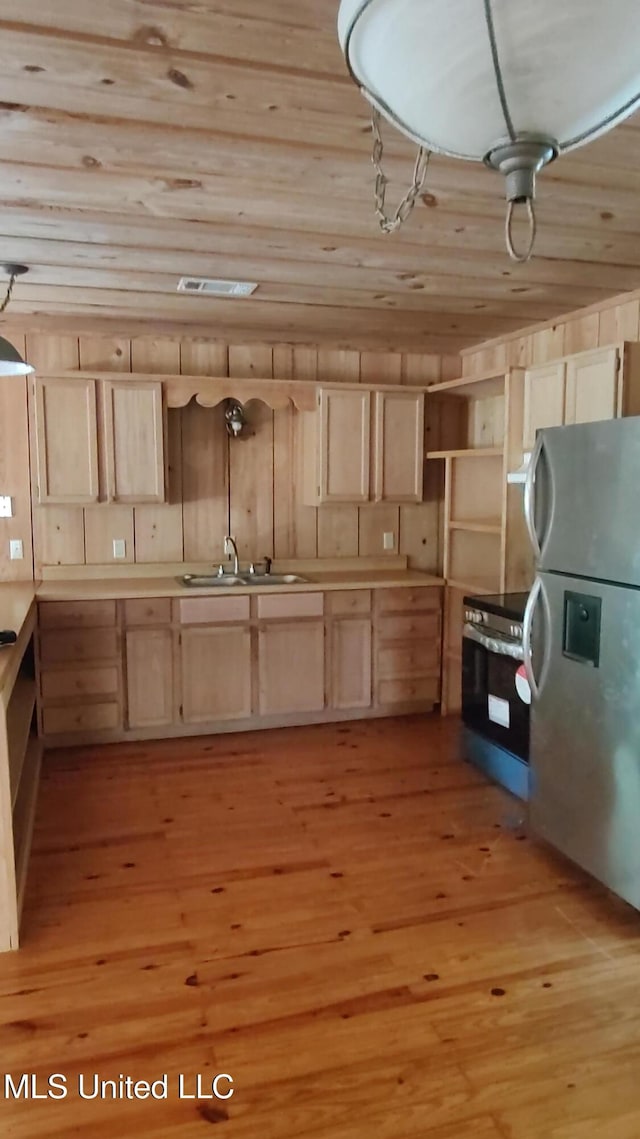 kitchen with stainless steel appliances, light brown cabinets, a sink, wood ceiling, and light wood-style flooring