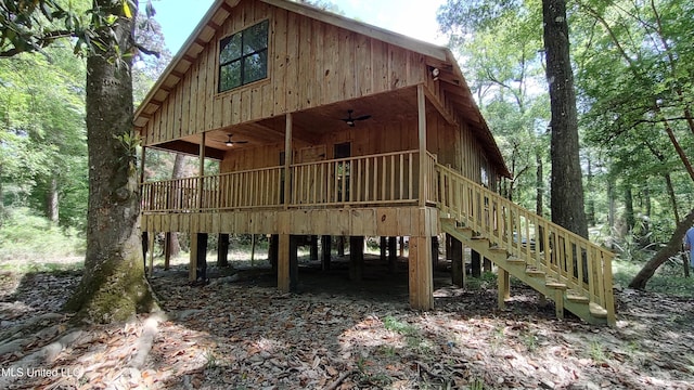 exterior space with stairway and a ceiling fan