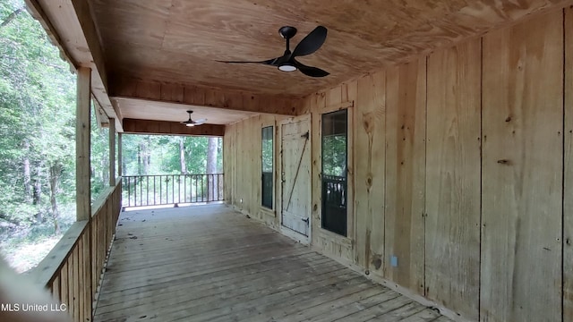 wooden terrace featuring a ceiling fan