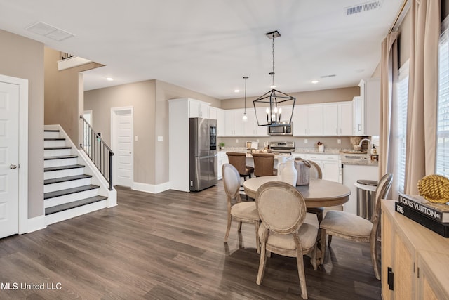 dining space with stairs, dark wood-style flooring, visible vents, and recessed lighting