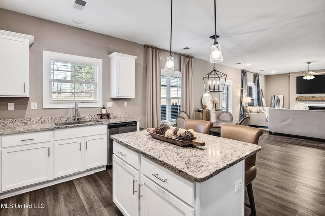 kitchen featuring a center island, dark wood-style flooring, visible vents, a sink, and dishwasher