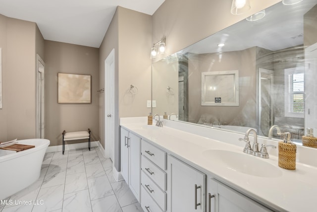 bathroom featuring a sink, baseboards, marble finish floor, a soaking tub, and double vanity