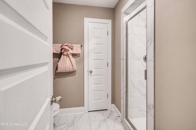 full bath with toilet, marble finish floor, baseboards, and a stall shower