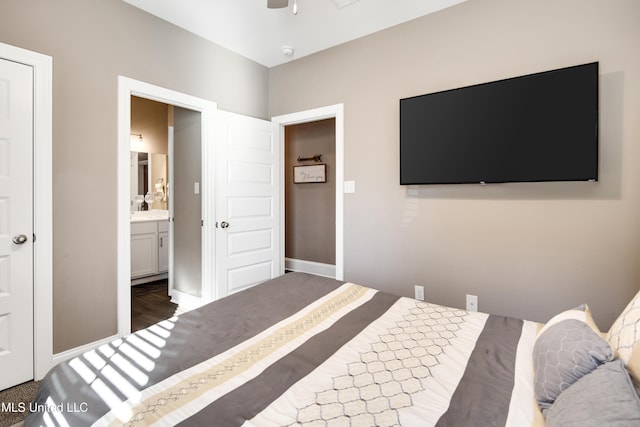 bedroom with ceiling fan, connected bathroom, and baseboards