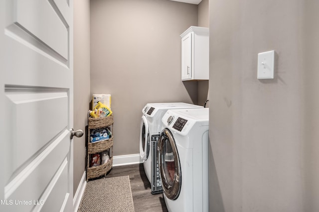 laundry area with cabinet space, baseboards, dark wood-type flooring, and independent washer and dryer