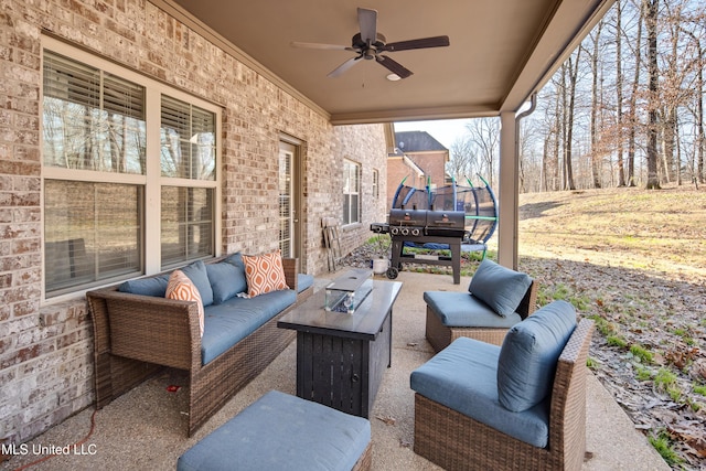 view of patio featuring a ceiling fan, an outdoor living space with a fire pit, and a grill