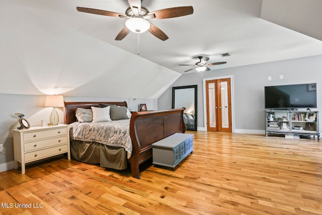 bedroom with vaulted ceiling, light wood-type flooring, and ceiling fan