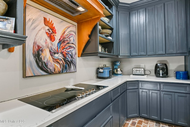 kitchen featuring black electric cooktop and light stone countertops