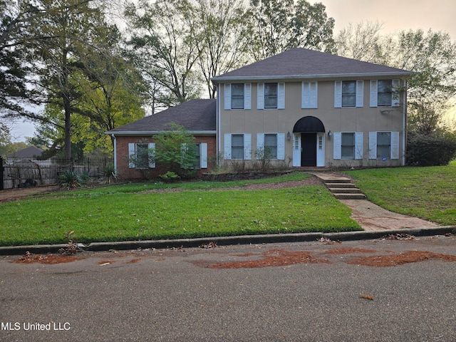 colonial house featuring a yard