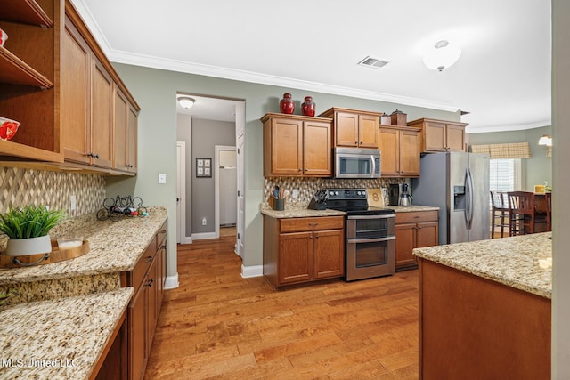 kitchen with visible vents, light wood-type flooring, brown cabinets, appliances with stainless steel finishes, and open shelves