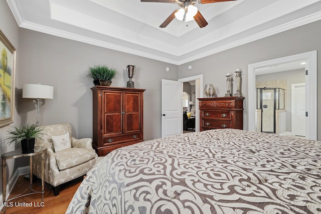 bedroom featuring ornamental molding, a raised ceiling, a ceiling fan, and wood finished floors