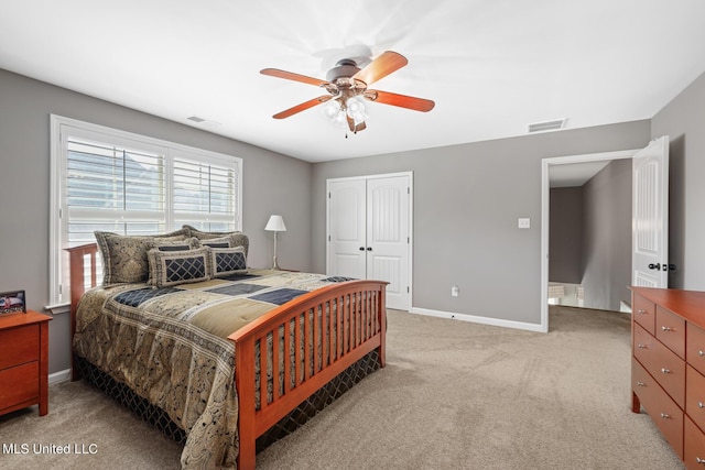 bedroom with visible vents, baseboards, light colored carpet, and a closet