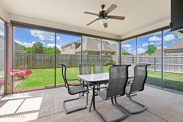 sunroom with a healthy amount of sunlight and ceiling fan