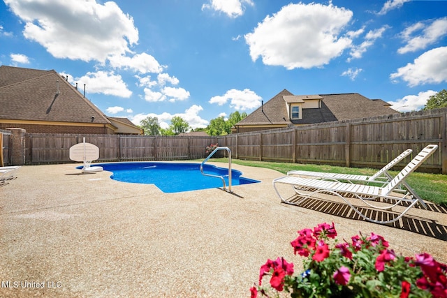 view of swimming pool with a patio and a fenced backyard