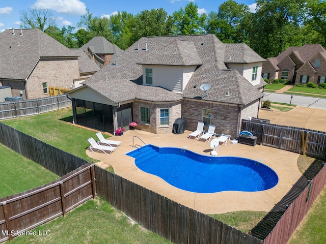 view of pool featuring a patio area, a fenced backyard, a lawn, and a grill