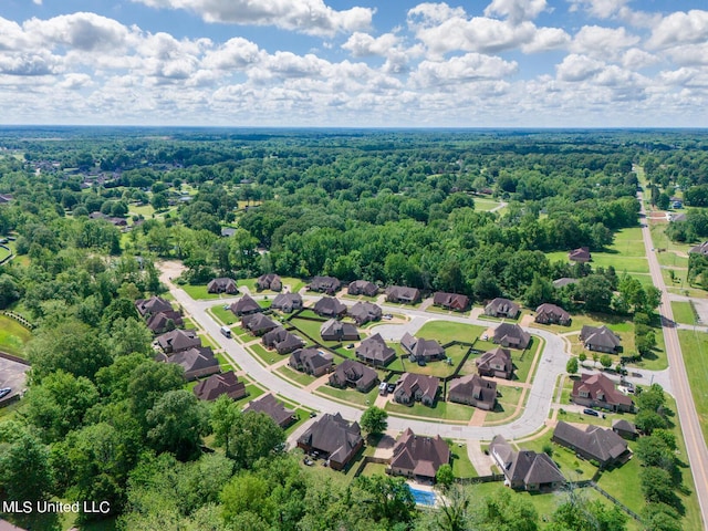 bird's eye view featuring a wooded view and a residential view