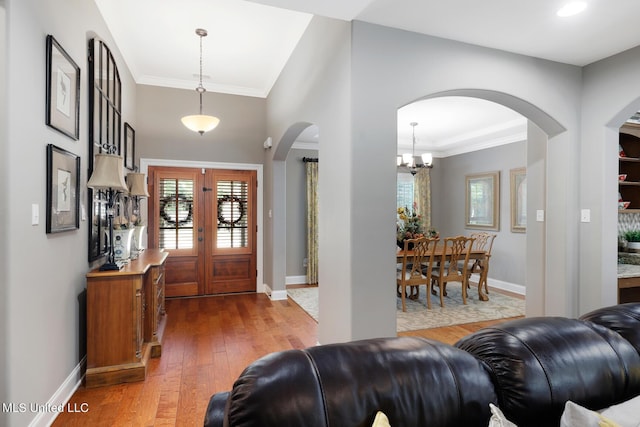 entryway featuring french doors, baseboards, hardwood / wood-style floors, and ornamental molding