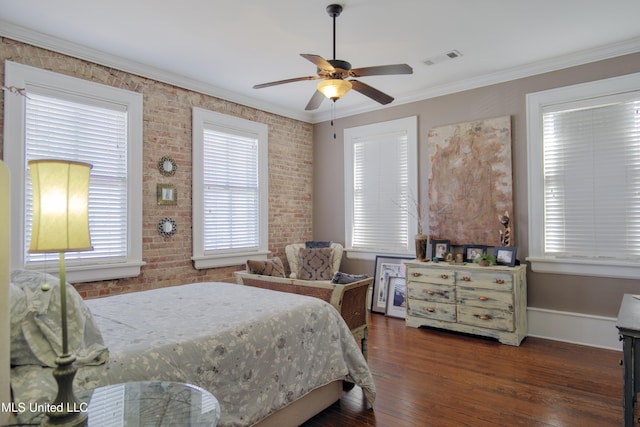 bedroom with ceiling fan, crown molding, dark wood-type flooring, and brick wall