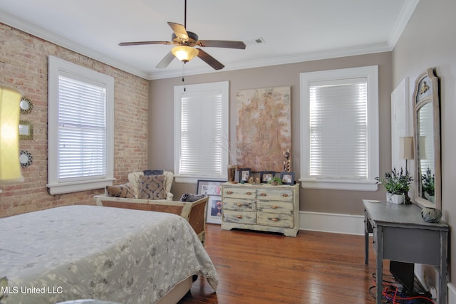 bedroom featuring hardwood / wood-style floors, ceiling fan, crown molding, and brick wall