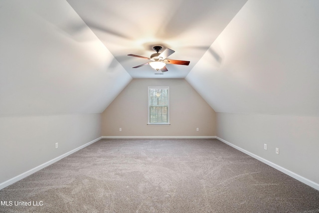 additional living space featuring ceiling fan, light colored carpet, and vaulted ceiling