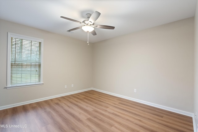 empty room with ceiling fan and light wood-type flooring