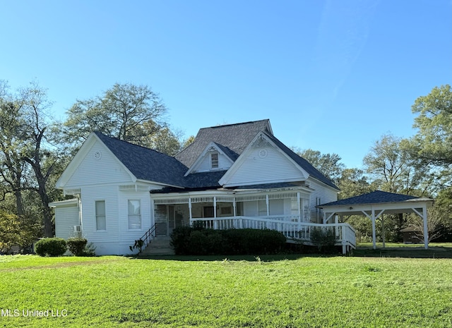 view of front of house featuring covered porch and a front lawn