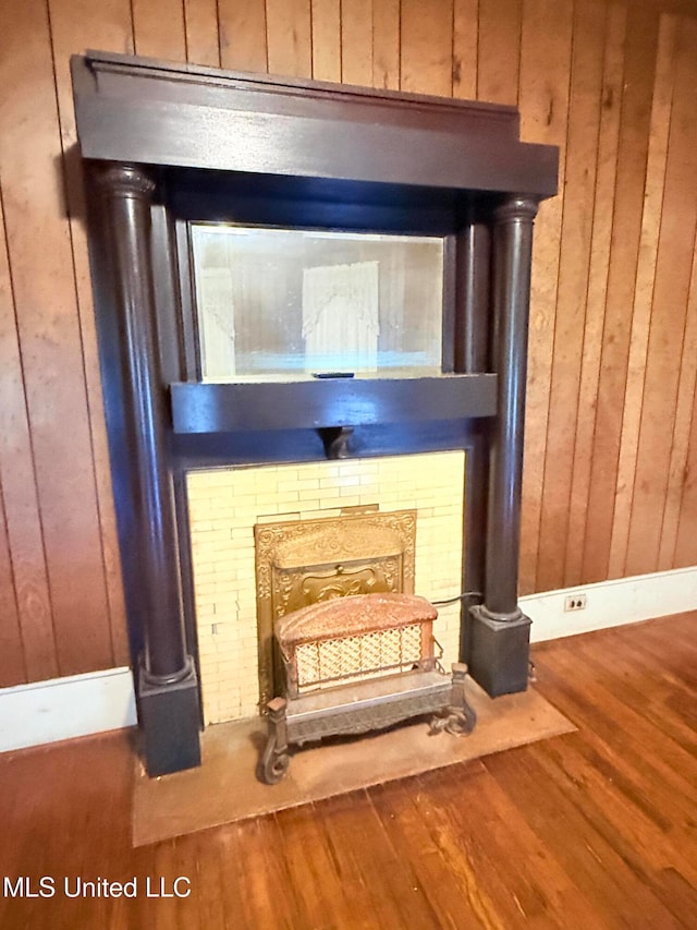 room details featuring hardwood / wood-style floors and wood walls