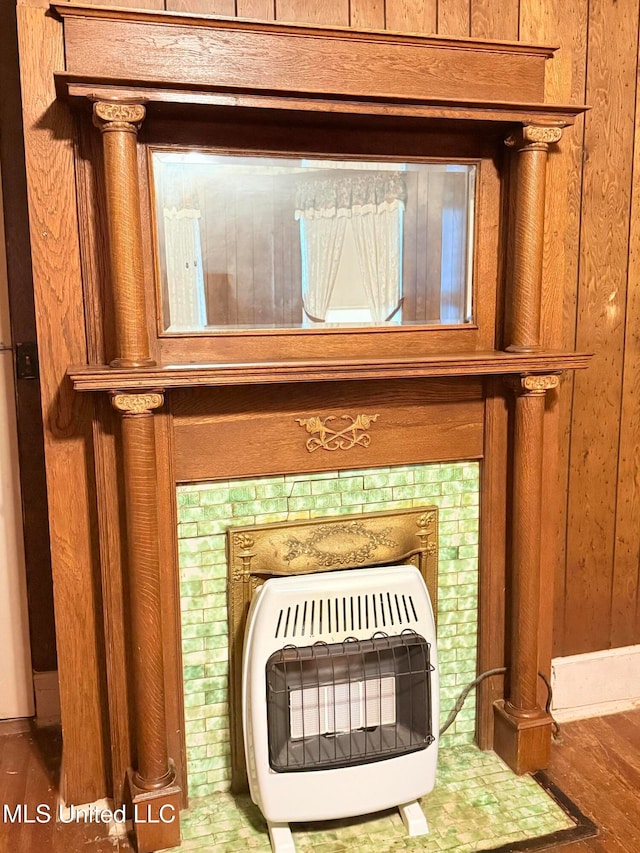 details featuring hardwood / wood-style floors, wooden walls, and heating unit