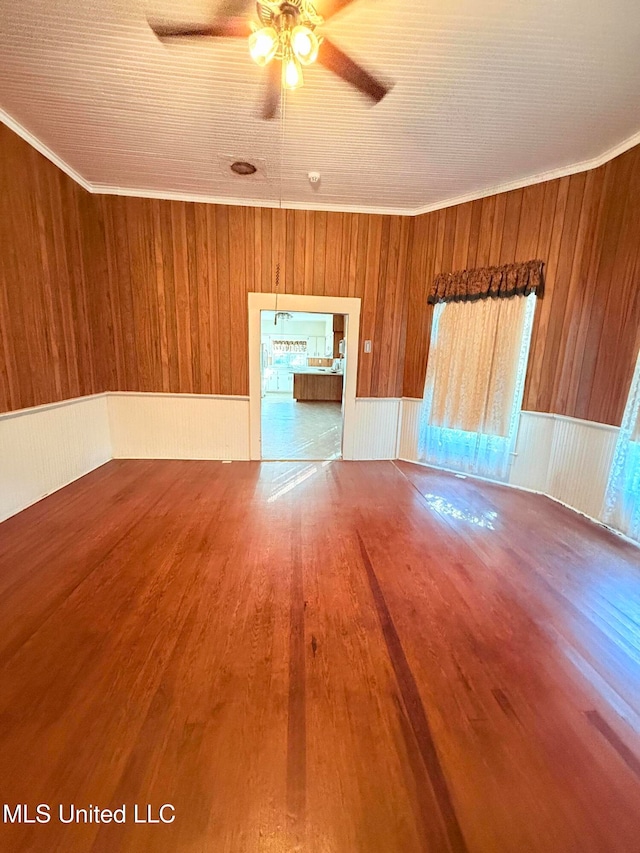 empty room with wood walls and hardwood / wood-style flooring