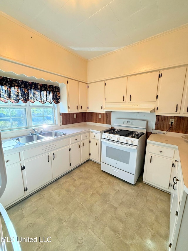 kitchen featuring white cabinetry, white gas range, and sink