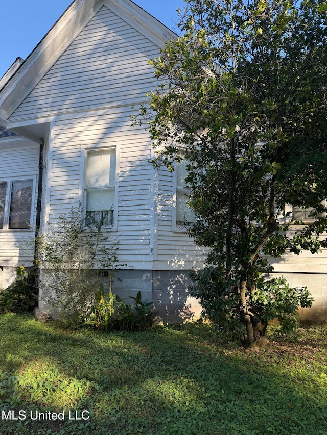 view of home's exterior with a lawn