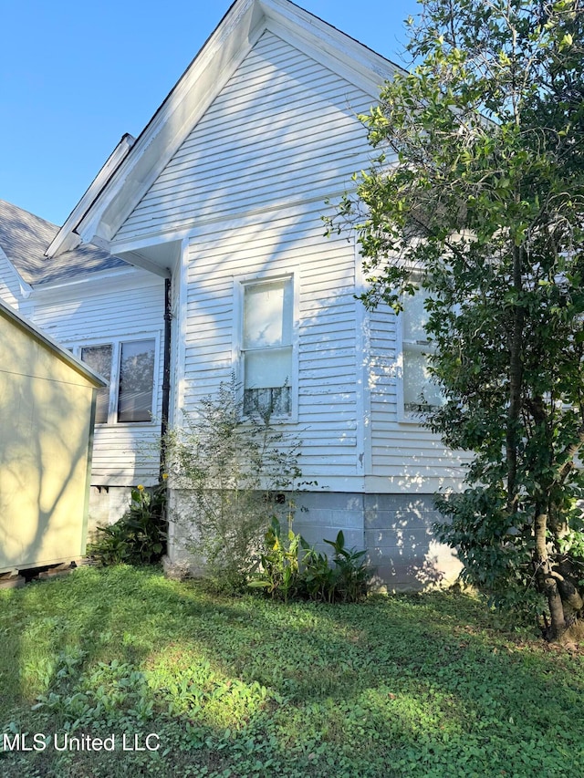 view of property exterior featuring a lawn