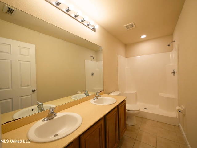 bathroom featuring visible vents, a sink, and tile patterned floors