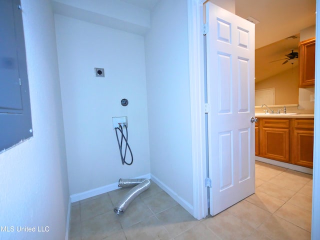 laundry area with light tile patterned floors, washer hookup, a sink, and hookup for an electric dryer