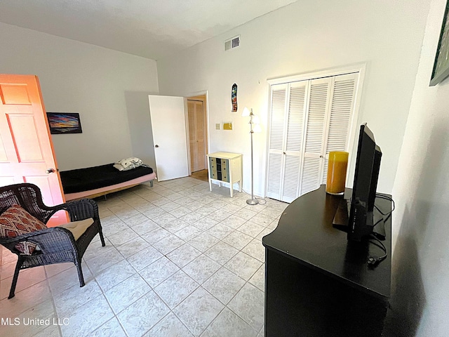 interior space with a closet and light tile patterned flooring