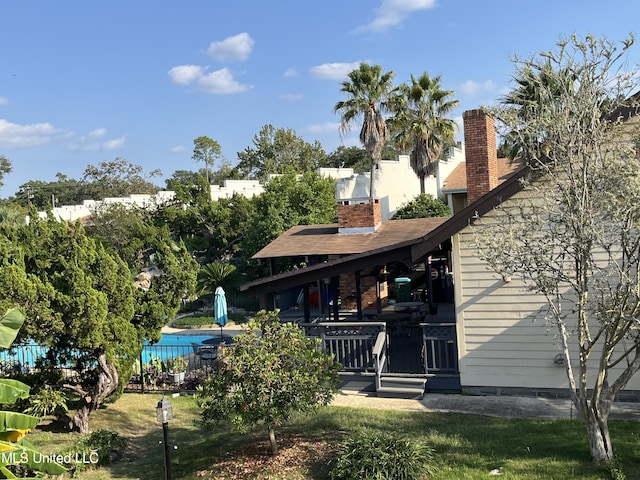 rear view of house featuring a swimming pool