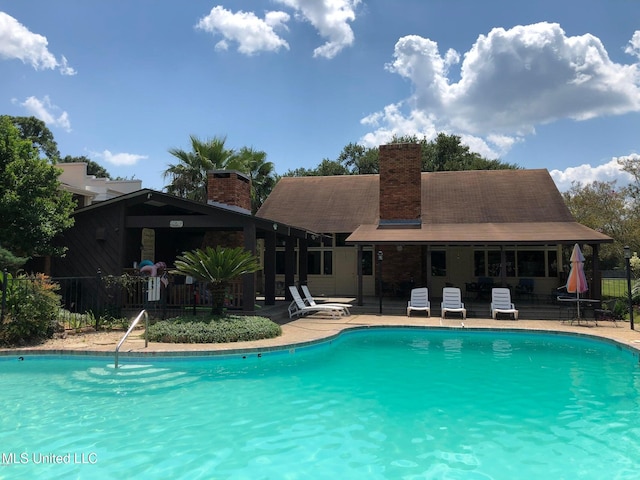 view of swimming pool with a patio area