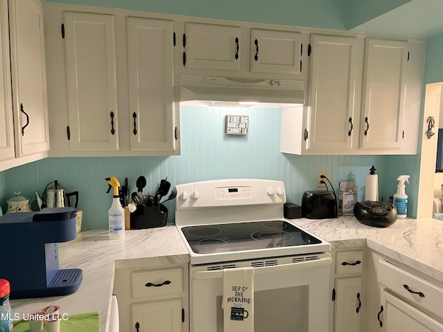 kitchen with white range with electric stovetop and white cabinets