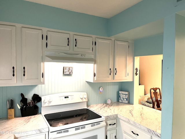 kitchen featuring white range with electric stovetop and white cabinets