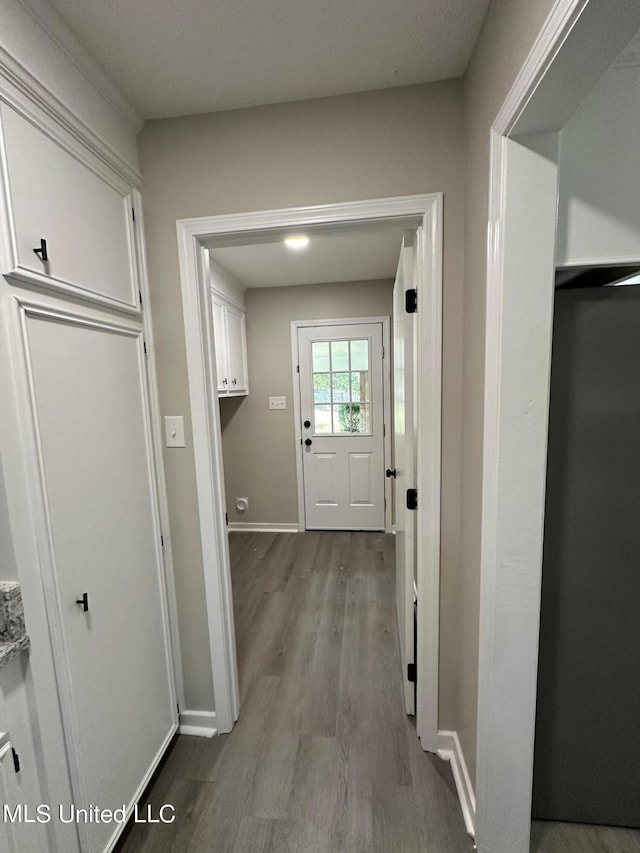 interior space with baseboards and wood finished floors